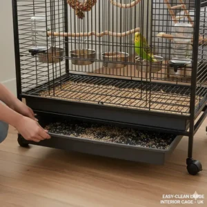 A large budgie cage featuring a slide-out debris tray for easy cleaning in a UK home.